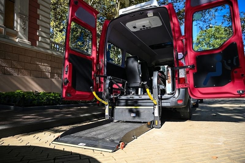 Wheelchair-accessible van with ramp deployed for boarding